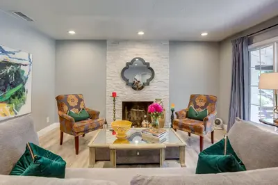a living room with two chairs and a fireplace at Family Home with Pool about 7 Mi to Downtown Sacramento! in Sacramento