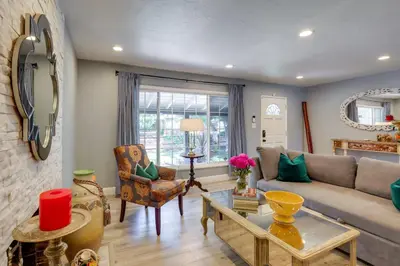a living room with a couch and a table at Family Home with Pool about 7 Mi to Downtown Sacramento! in Sacramento