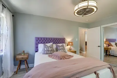 a bedroom with a large bed with a purple headboard at Family Home with Pool about 7 Mi to Downtown Sacramento! in Sacramento