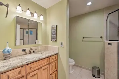 a bathroom with a sink and a toilet and a mirror at Luxurious Downtown Lodi Apartment in Wine Country! in Lodi