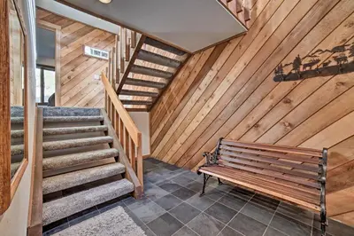 a wooden staircase with a bench in a room at The Mammoth Lodge by Hiking, Lakes, Skiing and More! in Mammoth Lakes