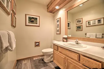 a bathroom with a sink and a toilet and a mirror at The Mammoth Lodge by Hiking, Lakes, Skiing and More! in Mammoth Lakes