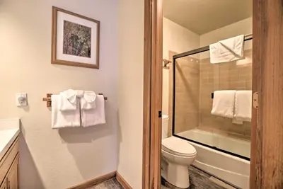 a bathroom with a toilet and a shower with towels at The Mammoth Lodge by Hiking, Lakes, Skiing and More! in Mammoth Lakes