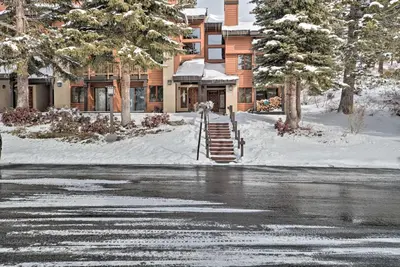 a snow covered street with a building in the background at The Mammoth Lodge by Hiking, Lakes, Skiing and More! in Mammoth Lakes