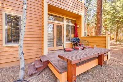 a wooden picnic table on the side of a house at 2 Mi to Diamond Peak! Corner-Unit Condo with Hot Tub in Incline Village