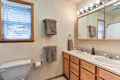 a bathroom with a toilet and a sink and a mirror at Forest Views and Beach Access Family Truckee Gem in Truckee