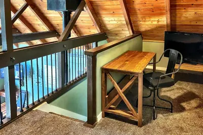 a wooden staircase with a table and a chair at Close to Donner Lake and Skiing Truckee Getaway in Truckee
