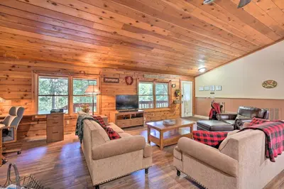a living room with wooden walls and wooden floors at 11 Mi to Apple Hill Pollock Pines Resort Cabin in Pollock Pines