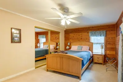 a bedroom with a bed and a ceiling fan at 11 Mi to Apple Hill Pollock Pines Resort Cabin in Pollock Pines