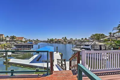 a dock with a marina with boats in the water at Waterfront Discovery Bay Home Outdoor Bar and Dock in Discovery Bay