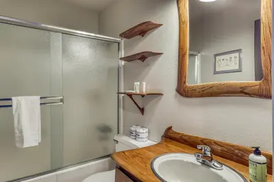a bathroom with a sink and a shower and a mirror at Heavenly View 4 U in Stateline
