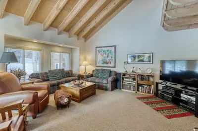 a living room with a couch and a dog in it at Spike's Place in Truckee