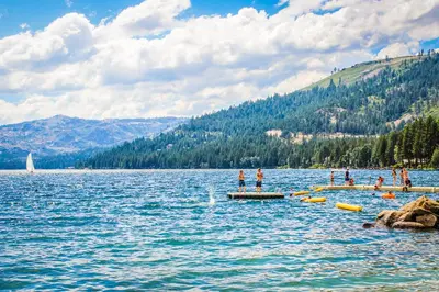 a group of people standing on a dock in a lake at Spike's Place in Truckee