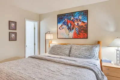 a bedroom with a bed with a painting of a dog at 1 Mi to Diamond Peak Ski Resort Forest-View Condo in Incline Village
