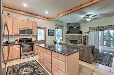 a kitchen with wooden cabinets and a stove top oven at Carnelian Bay Home with Hot Tub Near Tahoe Skiing in Carnelian Bay