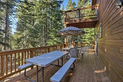 a deck with a picnic table and an umbrella at Carnelian Bay Home with Hot Tub Near Tahoe Skiing in Carnelian Bay