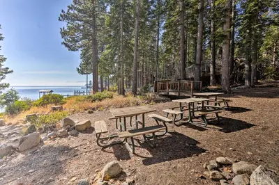 a group of picnic tables on a beach with trees at Carnelian Bay Home with Hot Tub Near Tahoe Skiing in Carnelian Bay