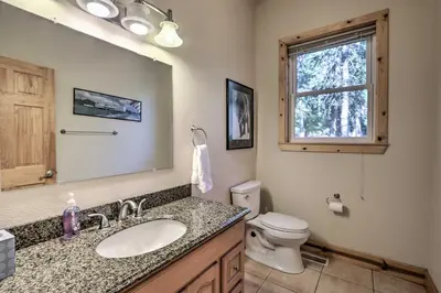 a bathroom with a sink and a toilet and a mirror at Carnelian Bay Home with Hot Tub Near Tahoe Skiing in Carnelian Bay