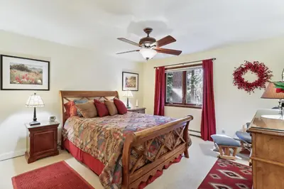 a bedroom with a bed and a ceiling fan at Lake Tahoe Family Home with Hot Tub and Game Room! in Incline Village