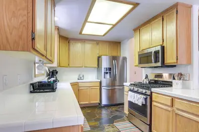 a kitchen with wooden cabinets and stainless steel appliances at 7 Mi to Northstar Resort Tahoe Vista Family Cabin in Tahoe Vista