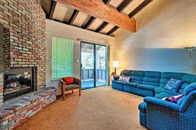 a living room with a blue couch and a fireplace at Ski Condo with Beach Access and 2 Mi to Diamond Peak! in Incline Village