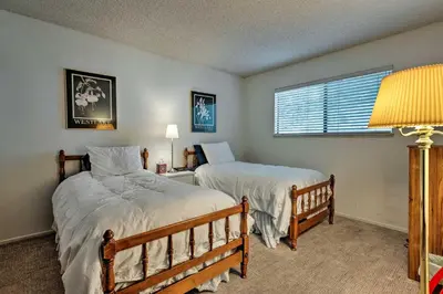 a bedroom with two beds and a window at Ski Condo with Beach Access and 2 Mi to Diamond Peak! in Incline Village