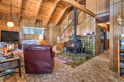 a living room with a fireplace and a stove at Near Hiking and Skiing Bear Valley Cabin! in Tamarack