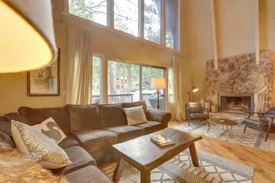 a living room with a couch and a fireplace at Near Skiing and Hiking Carnelian Bay Cabin in Carnelian Bay