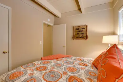 a bedroom with a bed and a sign on the wall at Near Skiing and Hiking Carnelian Bay Cabin in Carnelian Bay