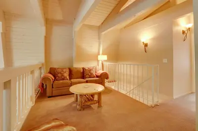 a living room with a couch and a table at Near Skiing and Hiking Carnelian Bay Cabin in Carnelian Bay