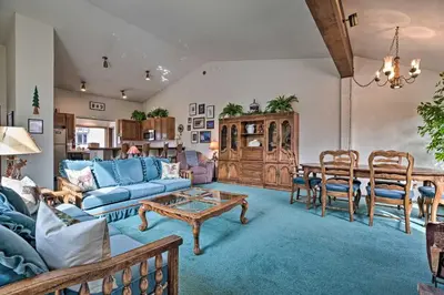 a living room with a blue couch and a table at Spacious and Cozy Condo, 1 Block To The Village in Mammoth Lakes