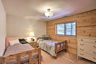 a bedroom with a bed and a window at Cabin with Hot Tub and BBQ Deck Less Than 4 Mi to Donner Lake! in Truckee