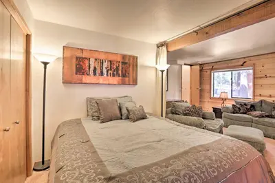 a bedroom with a bed and a living room at Cabin with Hot Tub and BBQ Deck Less Than 4 Mi to Donner Lake! in Truckee