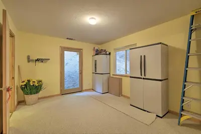 a kitchen with a refrigerator and a ladder at Walk to Big Trees State Park Cabin with Deck! in Dorrington