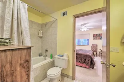 a bathroom with a bed and a toilet and a tub at Walk to Big Trees State Park Cabin with Deck! in Dorrington