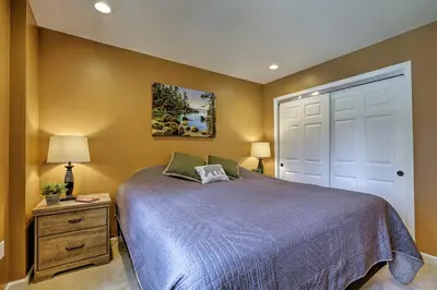 a bedroom with a blue bed and a white door at 1 Mi to Skiing and Beaches Incline Village Home! in Incline Village