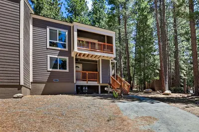 a house with a balcony in the woods at 1 Mi to Skiing and Beaches Incline Village Home! in Incline Village