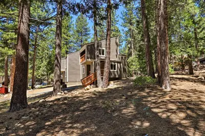 a house in the middle of a forest with trees at 1 Mi to Skiing and Beaches Incline Village Home! in Incline Village