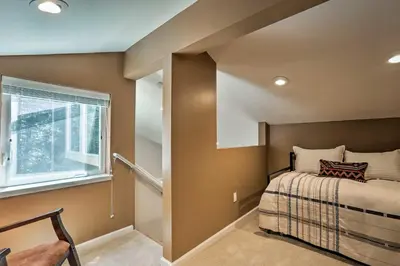 a small bedroom with a bed and a window at 1 Mi to Skiing and Beaches Incline Village Home! in Incline Village