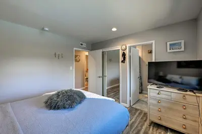 a bedroom with a bed and a dresser and a television at Updated Sacramento Home with Grill, Patio, and Pool! in Sacramento