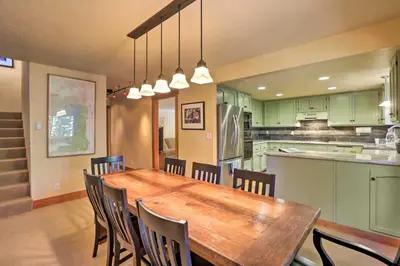 a kitchen and dining room with a wooden table and chairs at North Lake Tahoe Cabin 4 Mi to the Beach! in Tahoe Vista