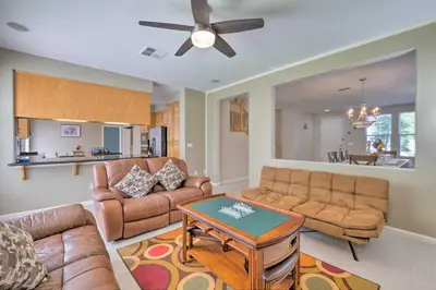 a living room with a couch and a table at Family-Friendly Tracy House with Patio and Grill! in Tracy