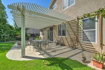 a patio with a table and chairs under a pergola at Family-Friendly Tracy House with Patio and Grill! in Tracy