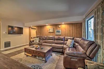 a living room with a leather couch and a coffee table at Mammoth Lakes Condo, Walk to Shuttle and Village in Mammoth Lakes