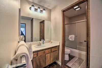 a bathroom with a sink and a toilet and a mirror at Mammoth Lakes Condo, Walk to Shuttle and Village in Mammoth Lakes