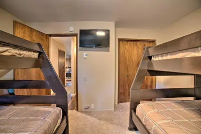 two bunk beds in a room with a bedroom at Mammoth Lakes Condo, Walk to Shuttle and Village in Mammoth Lakes
