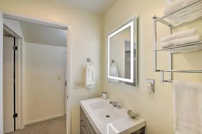 a white bathroom with a sink and a mirror at Cabin in Natl Forest 35 Min to Boreal Resort in Colfax