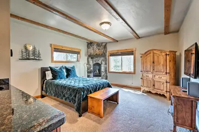 a bedroom with a bed and a tv and a table at Truckee Escape with Hot Tub Near Ski Resorts in Truckee