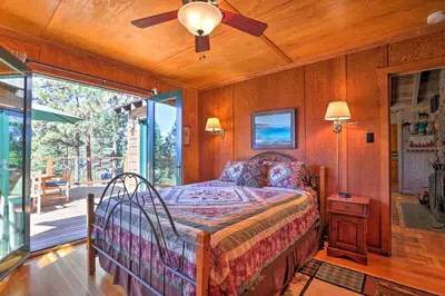 a bedroom with a bed and a ceiling fan at Hot Tub and Lake Tahoe Views Kings Beach Lodge in Kings Beach