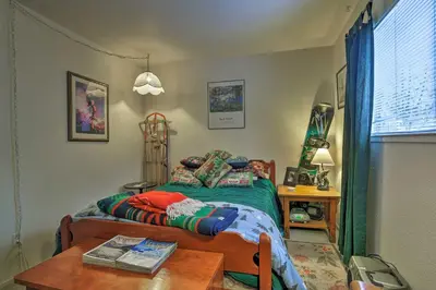 a small bedroom with a bed and a table at Home 1 Mi to Heavenly Mtn Resort! Unwind Fireside in South Lake Tahoe